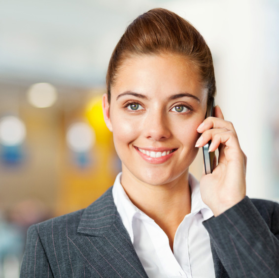 Smiling Business Woman talking on mobile phone at Airport